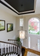 Painting the ceiling draws attention to the height of the space, as does arranging the framed at in a "stair step" look.