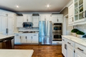 We further lightened and elevated the kitchen with marble countertops, best seen on the right side here. The mosaic also seen in the right and over the range added depth to a mostly white kitchen space.