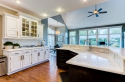 The kitchen cabinets, including the island, were the same orangish color of the media center. We lightened the upper cabinets while darkening the island cabinets.