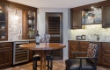 A full view of the wet bar area and new wine fridge. Notice the contrast between the stone and cabinetry, as well as how private the space feels despite being an open floor plan.
