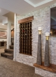 The addition of built-in wine rack, tall accessories and the darker wood ledge completes the sophisticated aesthetic that is front and center when the TV is on.