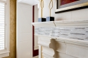 A closer view of the intricate mantle mosaic. You can also see the texture of the limestone fireplace extension above the mantle. 
