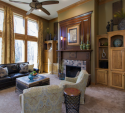 From the dark sofa and trunk table to the darker and cool color accents throughout the space, this room is a delightful example of light/dark and cool/warm working well together.