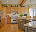 Here you can see the cool new glass handles on the island cabinets. Also, note the very neat multi-color dimensional tile mosaic over the range. 