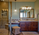 Tile and mosaic work was the focus of the shower and vanity as well. Keen-eyed observers will note the wall color is similar to the bedroom, and works well with the warmer wood tones.