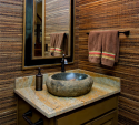 The lower level bathroom was transformed courtesy of a hewn stone sink and bamboo grass cloth wall coverings. Very neat!