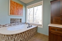 The master bathroom was also a total rebuild. The central focus is the new bath tub area with the intricate mosaic work and energetic wall art above the tub.