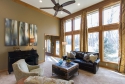 As we enter the living room, you immediately notice how light it is. The previous furniture was all light, so we added some dark contrast with thew furniture and accents.